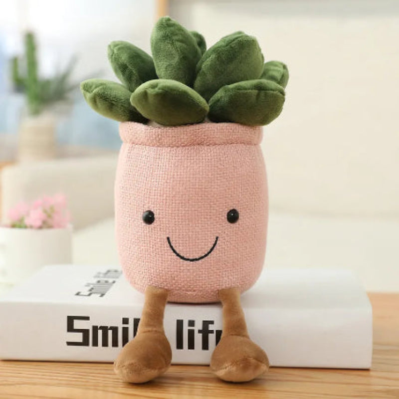 Plush toy shaped like a succulent plant with a pink pot on a book