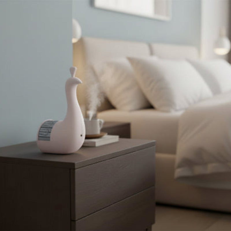  a nightstand featuring a pink goose-shaped object.