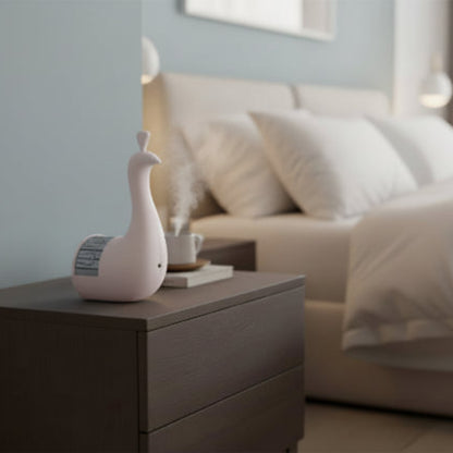  a nightstand featuring a pink goose-shaped object.