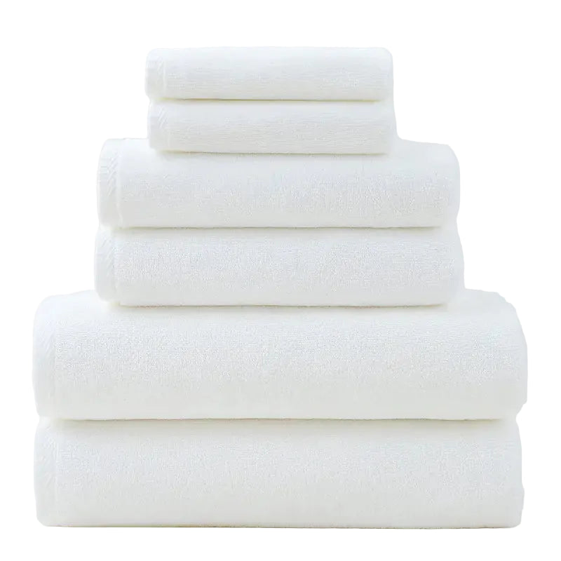 Stack of white towels on a light gray background